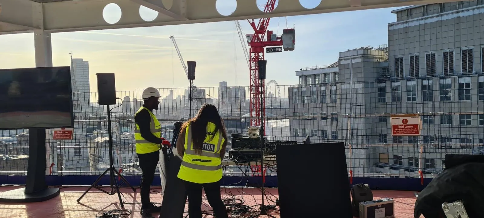 EMS Events crew rigging speakers on Stonecutter Court rooftop