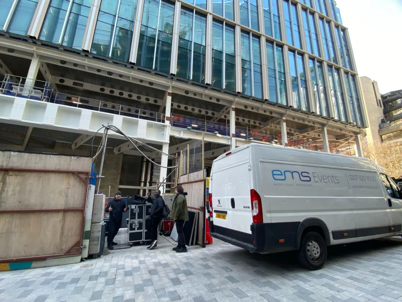 EMS Events van and crew loading AV flight cases at the Stonecutter Court site entrance in the City of London