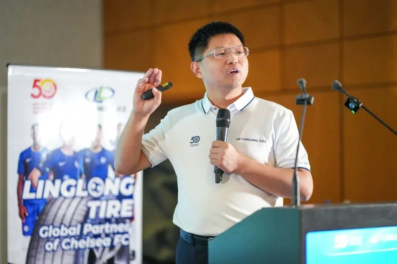 Linglong Tire executive speaking beside Chelsea FC partnership banner