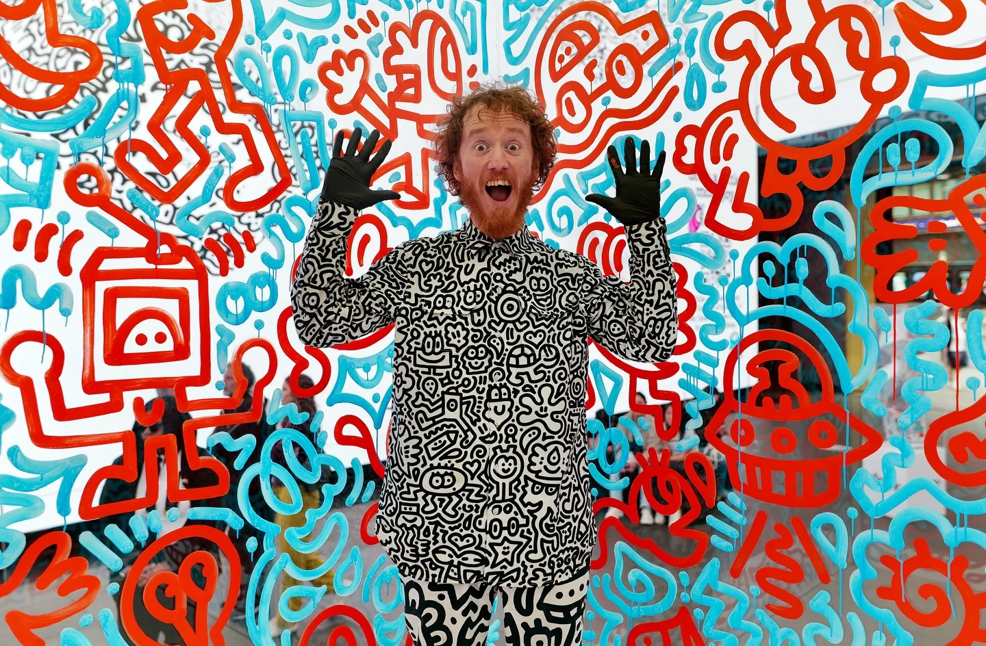 Mr Doodle posing inside doodle-covered Kleenex glass cube at Outernet London