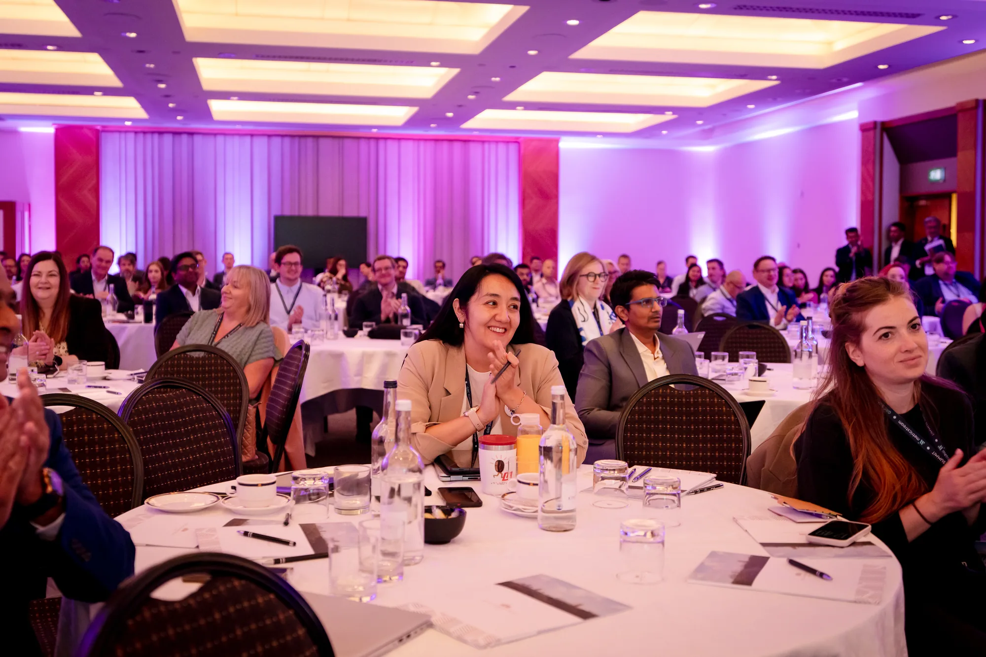 delegates-applauding-cabaret-seating-grc-summit-london-2026