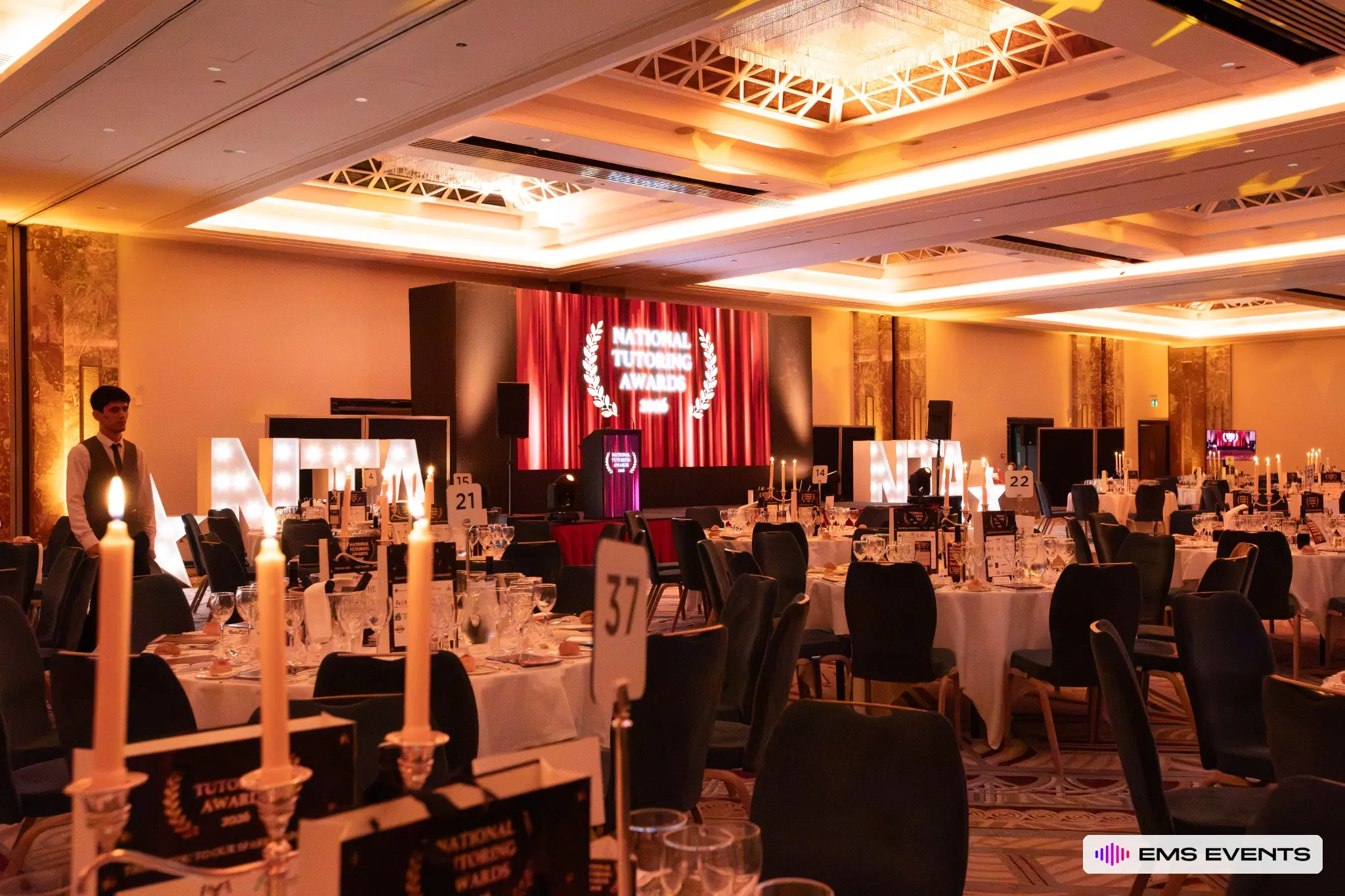 Candlelit banquet tables and stage lighting production for The Tutors' Association's 5th National Tutoring Awards