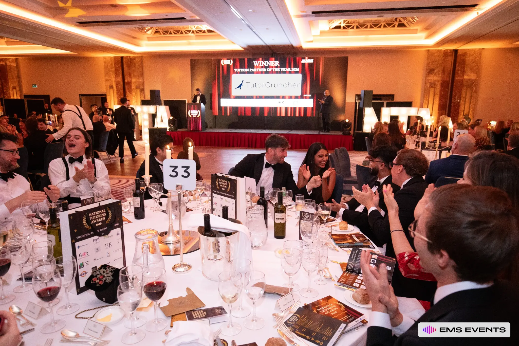 Table 33 guests celebrate as the Tuition Partner of the Year 2026 winner is announced on the main stage