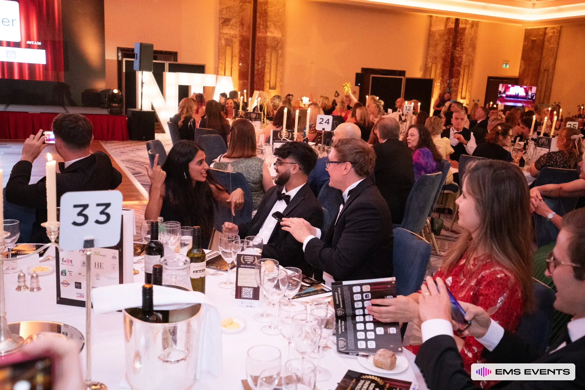 Guests in animated conversation between award announcements at the 5th National Tutoring Awards