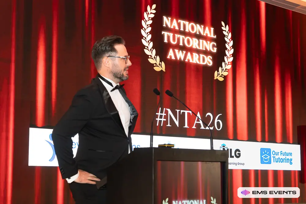 Host at the podium during The Tutors' Association's 5th National Tutoring Awards at Royal Lancaster London