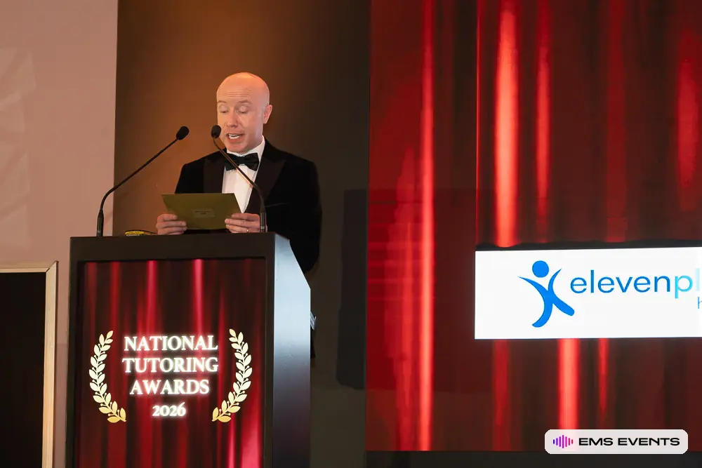 Host reads the winner envelope at the podium during The Tutors' Association's 5th National Tutoring Awards