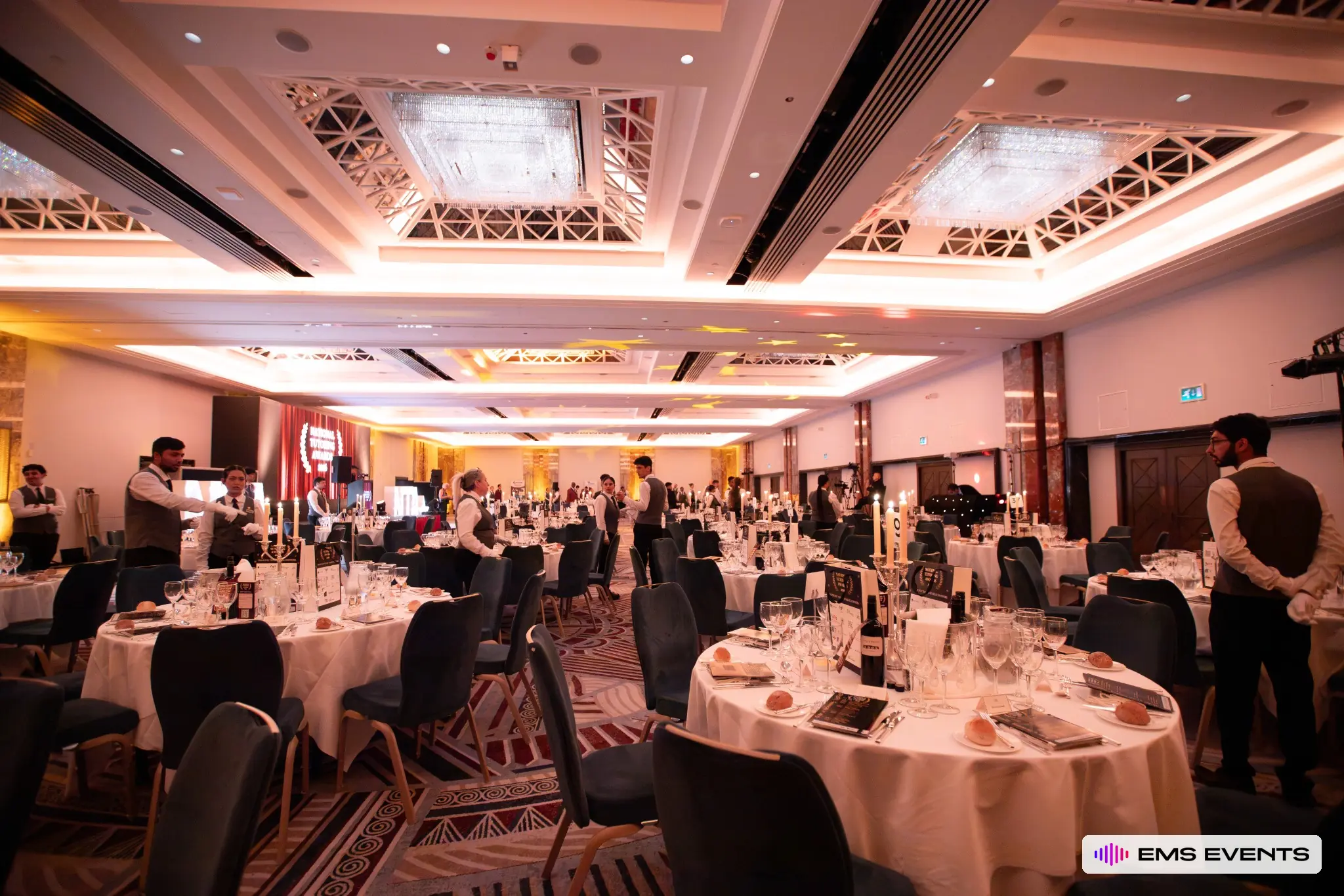 Event staff completing table setup before guests arrive at the 5th National Tutoring Awards ceremony