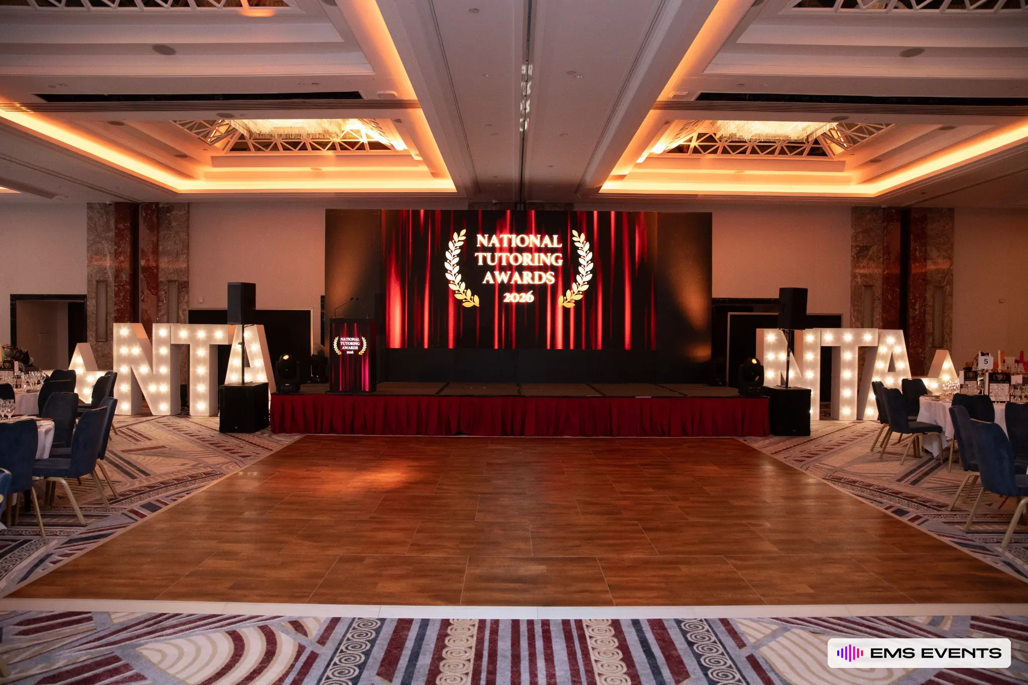 National Tutoring Awards 2026 stage setup with LED backdrop and NTA marquee letters, produced by EMS Events at Royal Lancaster London