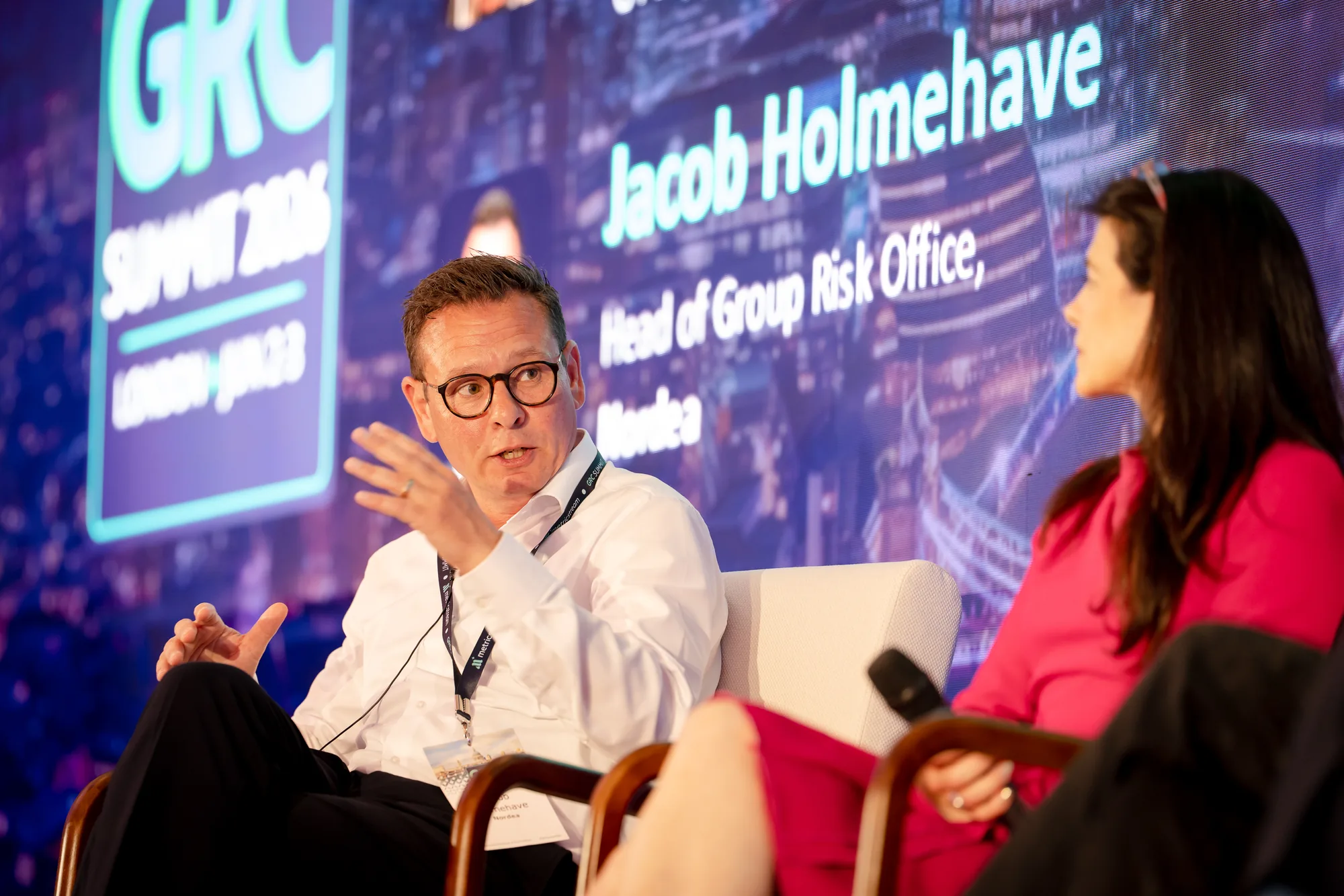 panelists-conversation-led-wall-name-graphic-grc-summit-2026