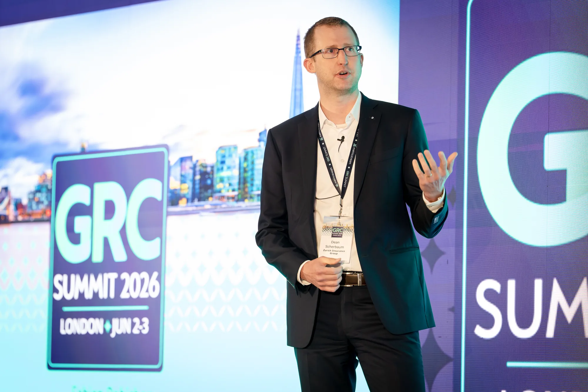 speaker-stage-led-wall-event-branding-grc-summit-london-2026