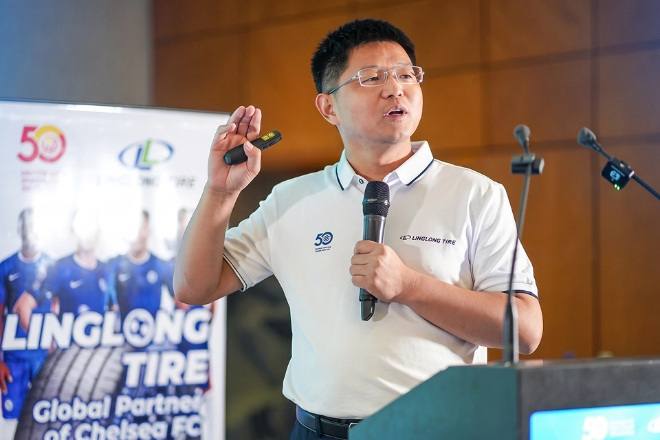 Linglong Tire executive speaking beside Chelsea FC_partnership banner